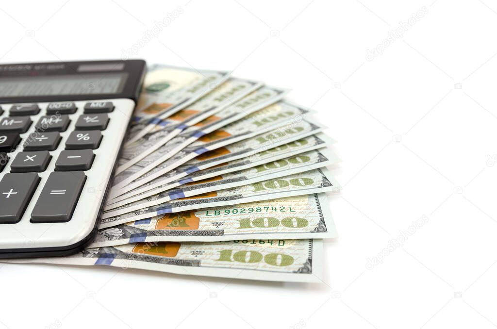 hundred dollar bills and calculator isolated on white background. Much money.