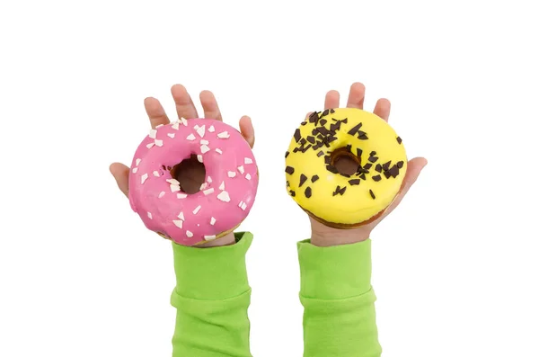 Twee Heerlijke Donuts Met Geel Roze Glazuur Kinderhanden Geïsoleerd Een — Stockfoto