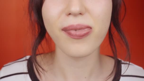 Junge Brünette Mädchen Mit Wunderschönen Lippen Auf Leuchtend Rotem Hintergrund — Stockvideo