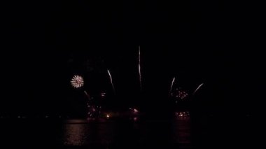 Gece gökyüzünde Bokeh ışıkları olan büyük, altın gibi havai fişekler. Parlak havai fişek gösterisi. Yeni yıl arifesi havai fişek kutlaması. Havai fişek Festivali.