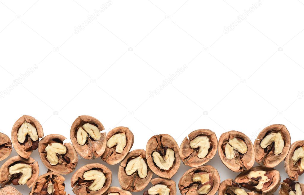 Cracked and open walnuts on a white background with copy space.