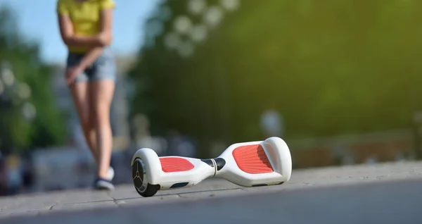 Meisje kind gewond haar elleboog tijdens het vallen van een hoverboard tijdens het rijden in een park — Stockfoto