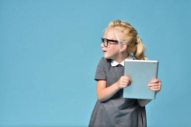 Gözlüklü çocuk ebeveyn kontrolünü ihlal etti ve tablet bilgisayarla oynuyor
