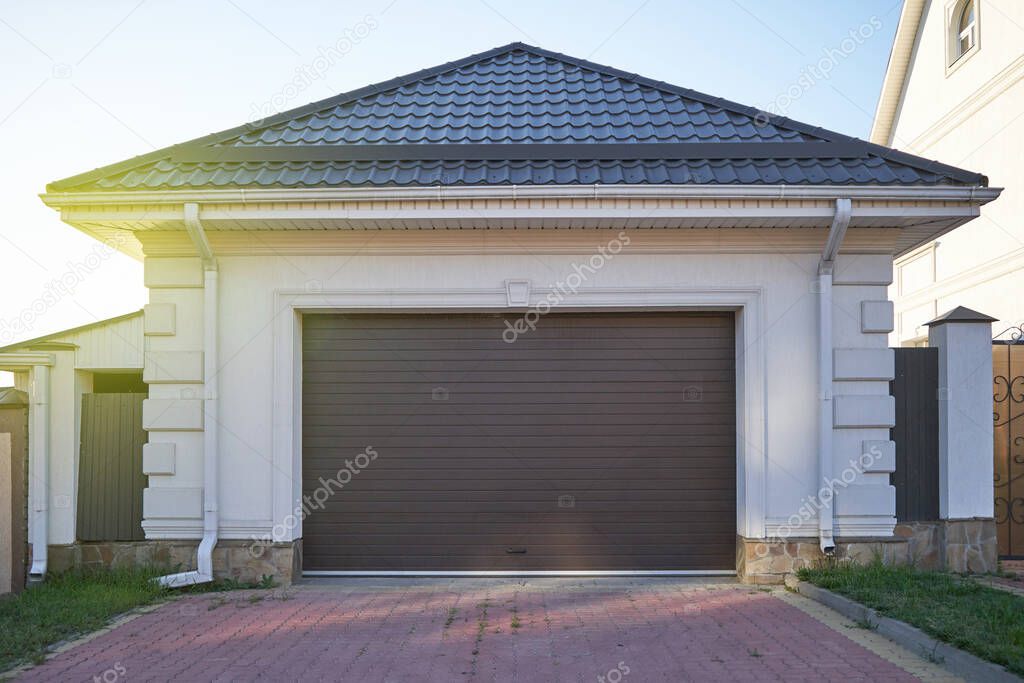 Garage with pitched roof and automatic garage door