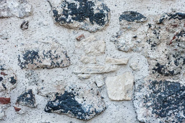 Eski bir binanın taş duvarının dokusu, antik mimari.