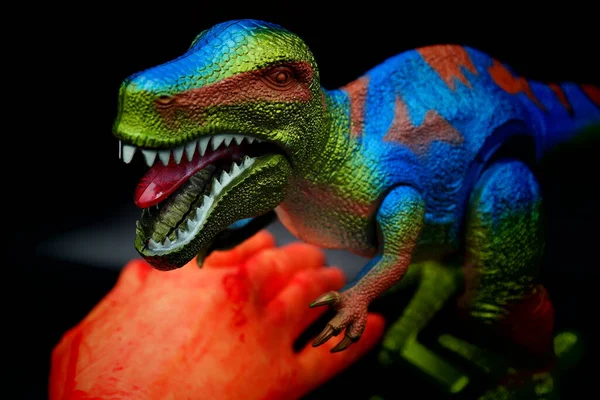 crocodile eat on the hunt with t-rex.tyrannosaurus rex eat people hand.t-rex eat hand.tyrannosaurus rex dinosaur.red dragon toy
