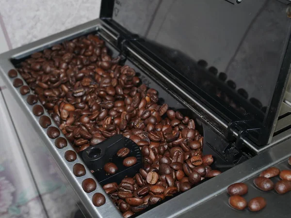 coffee beans and coffee grinder.baking cookies in oven.roasted coffee beans.coffee beans in a cup.coffee beans on a wooden table.coffee grinder with coffee beans.coffee maker machine
