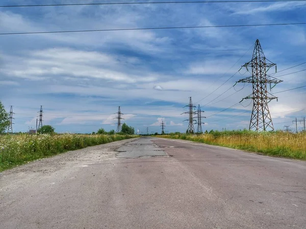 electric power lines.road in the countryside.high voltage tower.high voltage power lines.
