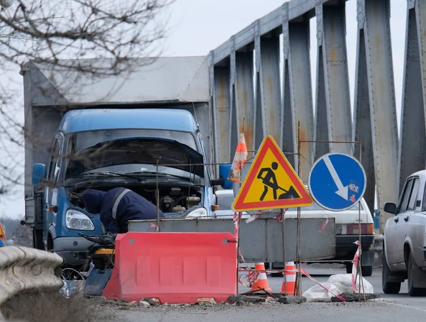 Road repair on the bridge in winter