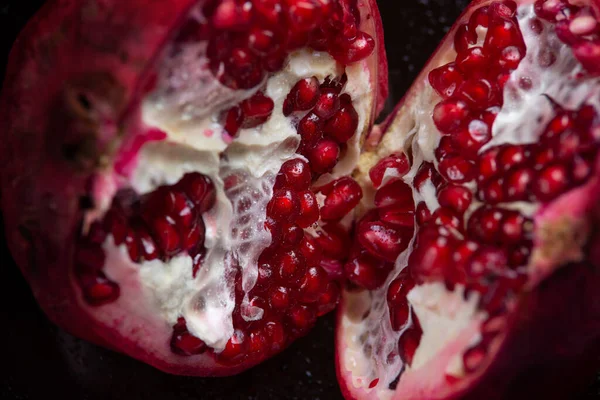 Close-up of a inner contents of a cut pomegranate. Background.