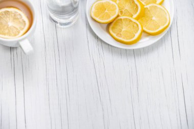 Halka açık bir hayat. Limon ve limon çayı beyaz masada. Salgın, kendini soyutlama üzerine.