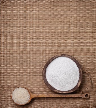 Hasır bir arka plan üzerinde bir Hindistan cevizi kasede pirinç unu. yukarıdan görüntüleyin. kopya alanı