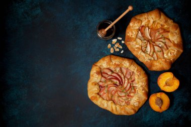 Mavi arka planda şeftalili bir galette. Yukarıdan bak. Boşluğu kopyala