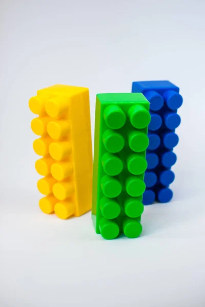 Bright details of the children's plastic designer: yellow, blue and green — Stock Photo, Image