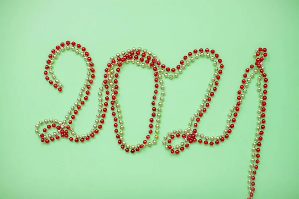 Happy New year 2021 celebration. Inscription 2021 from gold and red shiny new year beads — Stock Photo, Image