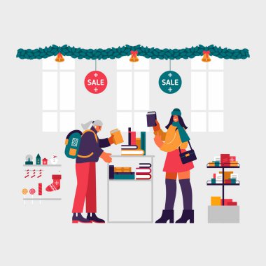 Kadınlar kitapçıda Noel hediyelerini satışta seçiyorlar