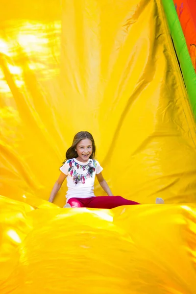 Happy Little Girl Having Lots Fun Jumping Castle While Sliding — Stock Photo, Image