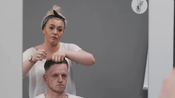 SAVAŞ, POLAND - 10 Haziran 2019: stilistin kapanışı saç modellemesini bitirmek için elleri kullanır