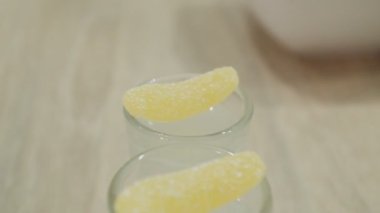 Barmen bardakları marmelatla süslüyor. Bir tanesi bardağa düştü.