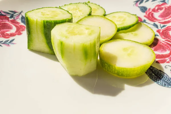 Fresh cucumber salad on white plate. Sliced fresh cucumbers. — Stock Photo, Image