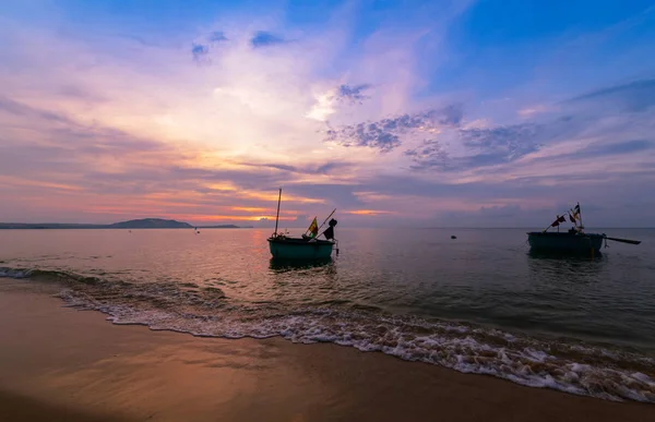 beautiful sunrise and boats for fishing on the sea in Mui Ne, Vietnam