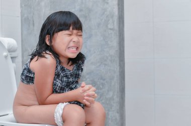Küçük kız mide acı ve oturup tuvalet, ishal kabızlık ve sağlık kavramı