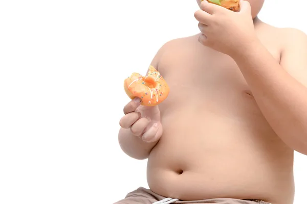 肥満脂肪の少年を押し 白い背景 ジャンク フードとダイエットの概念に分離されたドーナツを食べる — ストック写真