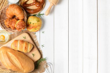 Ev yapımı ekmek veya beyaz tahta arka plan, kahvaltı gıda kavramı üstten görünüm ve kopya alanı topuz, kruvasan ve fırın malzemeleri