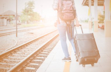 Vintage sesi, kavram seyahat ve eğlence tren istasyonunda hipster kadın çekme siyah deri vintage çanta