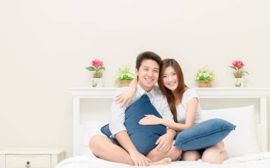 Mutlu çiftler gülümseme ve evde yatak, sevgi ve romantik kavramı üzerinde oturan