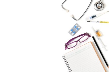 Boş defter ile stetoskop ve beyaz arka plan üzerinde sağlık izole doktor için aksesuarlar bakım kavramı ve kopyalama alanı