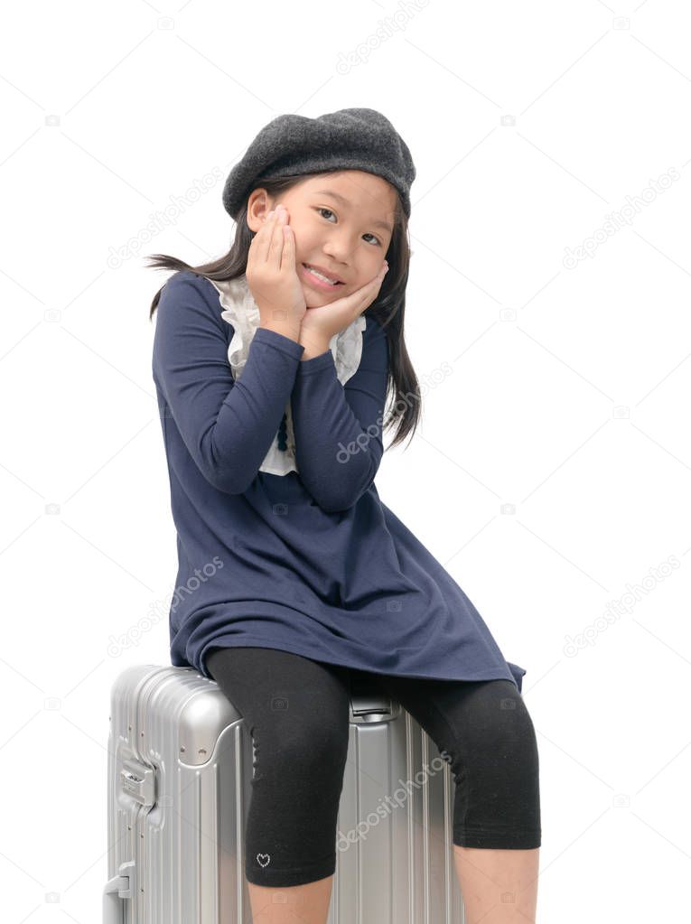 Happy asian girl sit on the baggage isolated on white background, travel concept