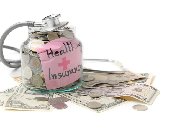 Stethoscope on a jar contains coins — Stock Photo, Image