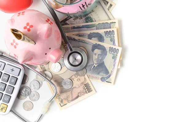 Stetoskop Japaness jenów banknotów i Skarbonka — Zdjęcie stockowe