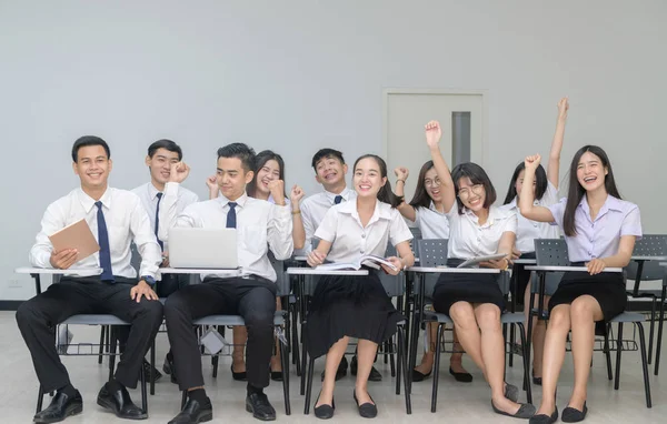 Happy Students in uniform working with laptop — Stock Photo, Image