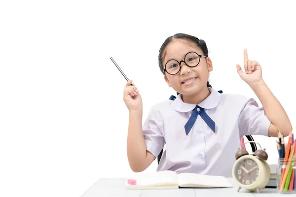 Милий азіатський студент робить домашнє завдання на столі ізольовані — стокове фото