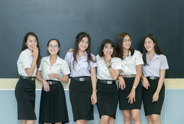Счастливые подростки, стоящие вместе в классе — стоковое фото