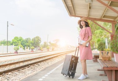 Hippi kız bekleyen tren ile deri vintage çanta 
