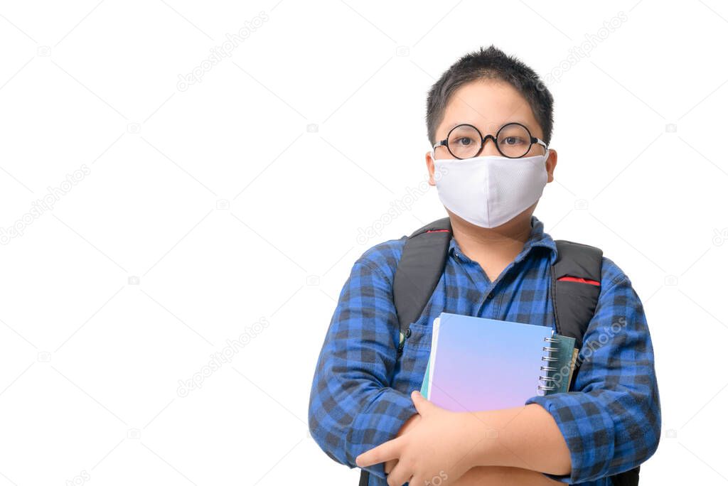 A high school boy student wear mask and eye glasses carrying  backpack isolated on white background, back to school new normal concept