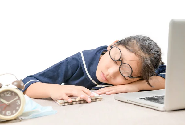 Tried student fell asleep while doing homework with the laptop isolated on white background, education concept