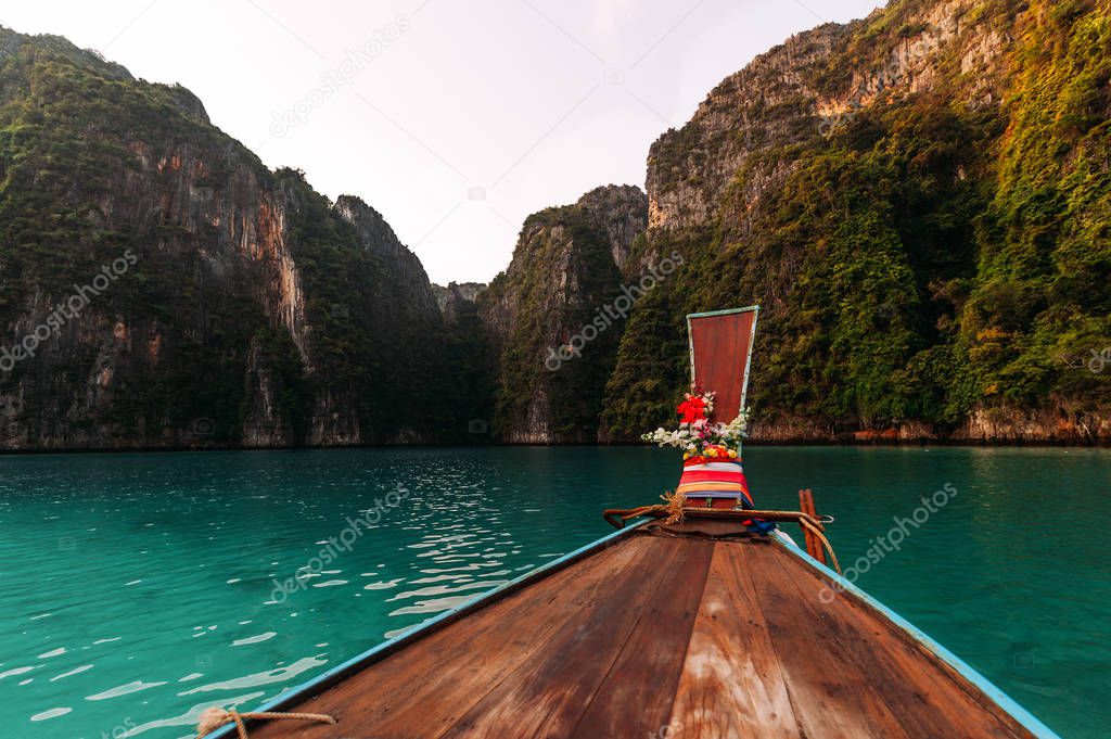 Old wooden boat on Asian Islands. Asian Islands. Thai Phi Phi Islands. Thai wooden boat. Boat in the Bay. Travelling to Asia. Travel to Thailand. Lagoon on the island. Boating around the island