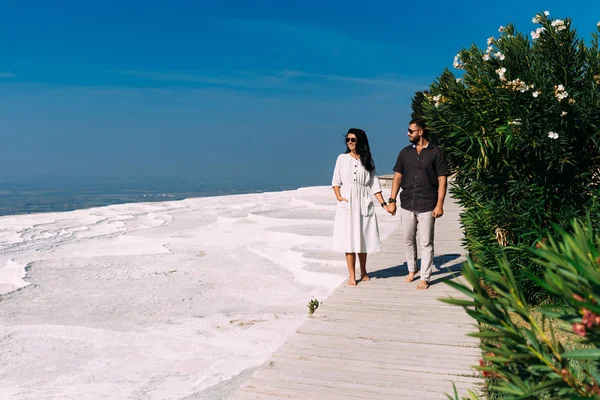 Man and woman traveling. Couple in love walking. Couple in Pamukkale. Travelling to Turkey. Lover. Honeymoon trip. Guy and girl are traveling. Wedding travel. Newly married couple. Honeymoon