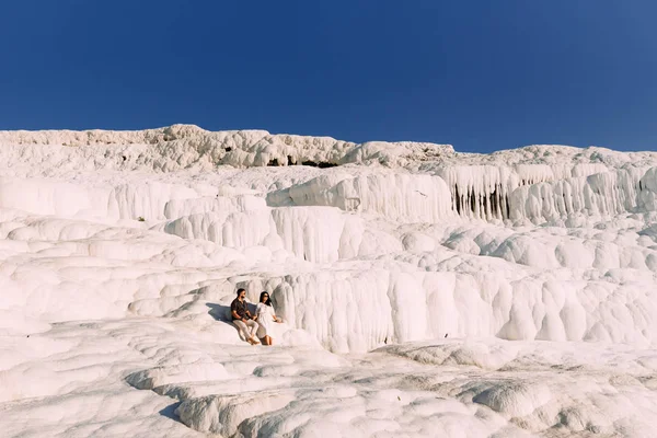 Couple in love in Turkey, Pamukkale. Stylish couple in love. Newly married couple. Happy couple on geothermal vents. Lovers at sunset. Pamukkale is an area in Turkey with geothermal sources