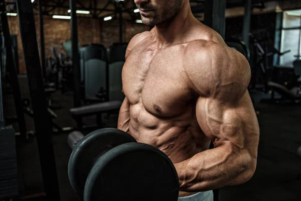 Brutal strong athletic men bodybuilder trains in the gym — Stock Photo, Image