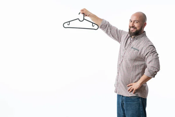 Man holds in his hand a hanger isolated on white — Stock Photo, Image