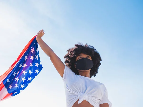 Fiatal Fekete Szabadban Védőmaszkot Visel Koronavírus Ellen Amerikai Zászlót Tart — Stock Fotó