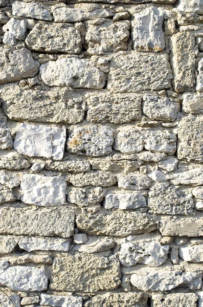 Old relief ecru limestone wall closeu