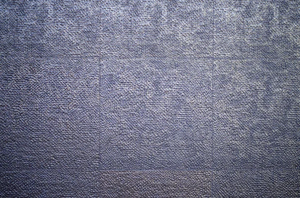 Glanzende opluchting bekleding tegels op de muur closeup — Stockfoto
