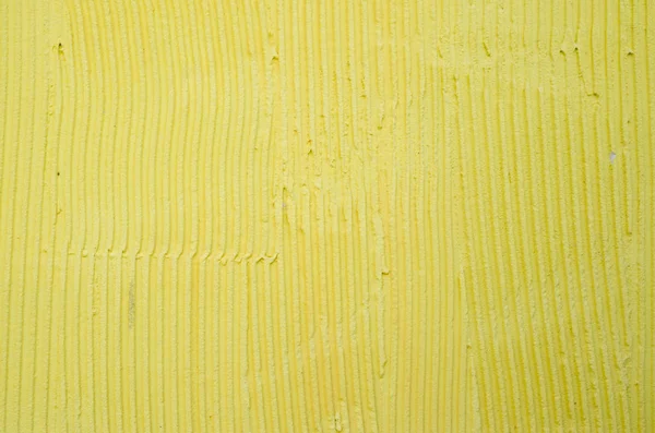 New yellow rough relief plaster on wall — Stock Photo, Image