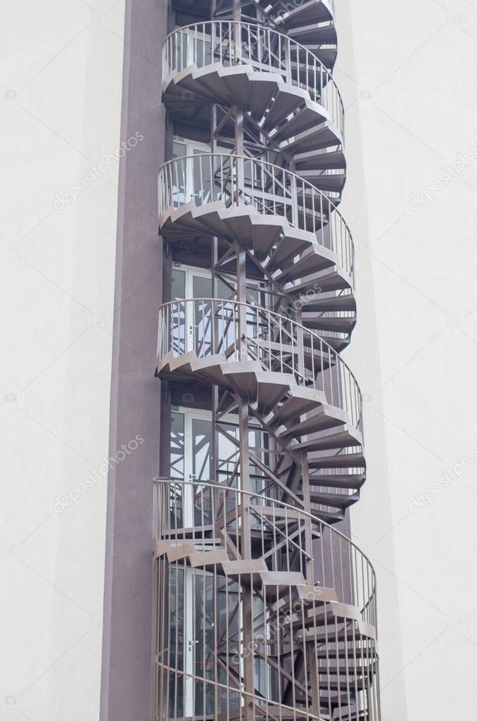 Spiral fire escape stairs outside building facade in hotel